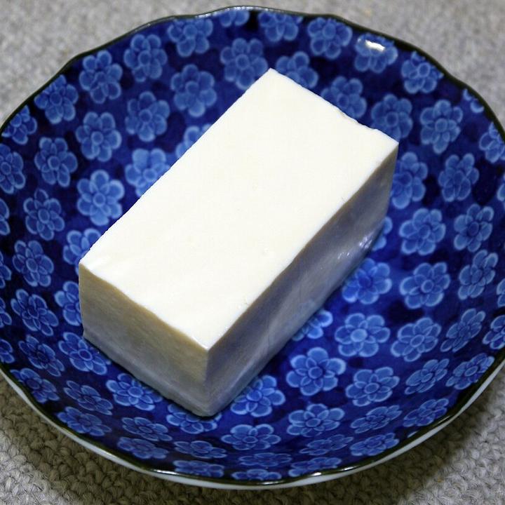Japanese silken tofu on a blue plate, a soft protein food for babies